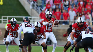 Oct 25, 2025; Lubbock, Texas, USA;  Texas Tech Red Raiders quarterback Mitch Griffgis (12) takes a snap from center in the second half during the game against the Oklahoma State Cowboys at Jones AT&T Stadium. Mandatory Credit: Michael C. Johnson-Imagn Images