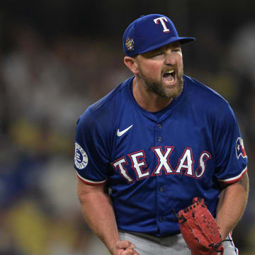 Jun 13, 2024; Los Angeles, California, USA;  Texas Rangers relief pitcher Kirby Yates (39) reacts after the final out of the ninth inning to earn a save against the Los Angeles Dodgers at Dodger Stadium. Mandatory Credit: Jayne Kamin-Oncea-USA TODAY Sports