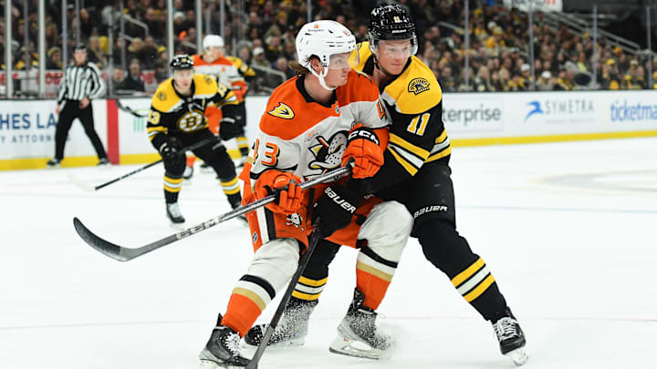 Feb 22, 2025; Boston, Massachusetts, USA; Anaheim Ducks defenseman Drew Helleson (43) and Boston Bruins center Trent Frederic (11) battle for position during the third period at TD Garden. Mandatory Credit: Bob DeChiara-Imagn Images