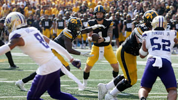 Iowa’s Brendan Sullivan (1) hands the football off to Kaleb Johnson (2) while playing Washington Saturday, Oct. 12, 2024 at Kinnick Stadium in Iowa City, Iowa.