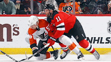 Stefan Noesen (Devils #11) wrestling Rasmus Ristolainen (Flyers #55)