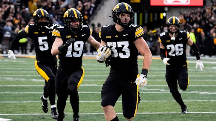Iowa Hawkeyes linebacker Cam Buffington (33) runs the ball after intercepting a pass during a game against the Minnesota Golden Gophers Oct. 25, 2025 at Kinnick Stadium in Iowa City, Iowa.