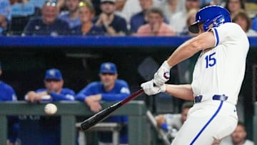 Sep 3, 2024; Kansas City, Missouri, USA; Kansas City Royals third baseman Paul DeJong (15) hits a one-run sacrifice against the Cleveland Guardians in the sixth inning at Kauffman Stadium. Mandatory Credit: Denny Medley-Imagn Images