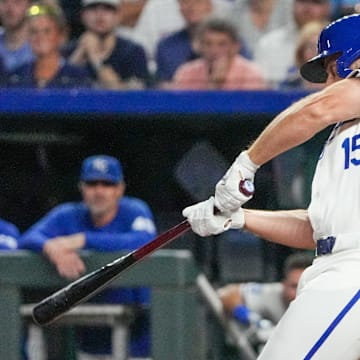 Sep 3, 2024; Kansas City, Missouri, USA; Kansas City Royals third baseman Paul DeJong (15) hits a one-run sacrifice against the Cleveland Guardians in the sixth inning at Kauffman Stadium. Mandatory Credit: Denny Medley-Imagn Images