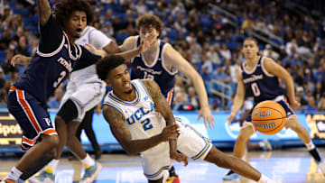 Nov 7, 2025; Los Angeles, California, USA;  UCLA Bruins guard Donovan Dent (2) passes the ball during the first half against the Pepperdine Waves at Pauley Pavilion presented by Wescom Financial. Mandatory Credit: Kiyoshi Mio-Imagn Images