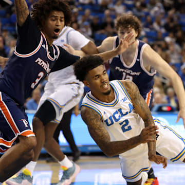Nov 7, 2025; Los Angeles, California, USA;  UCLA Bruins guard Donovan Dent (2) passes the ball during the first half against the Pepperdine Waves at Pauley Pavilion presented by Wescom Financial. Mandatory Credit: Kiyoshi Mio-Imagn Images