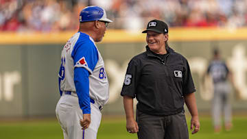 Umpire Jen Pawol (95) reacts with Atlanta Braves third base coach Fredi González (86) during the game against the Miami Marlins at Truist Park on Saturday.