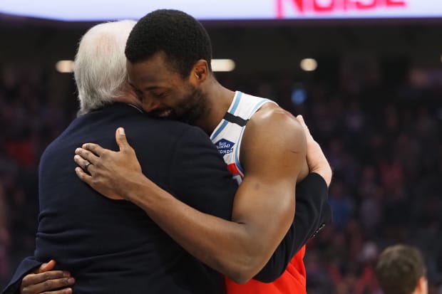 San Antonio Spurs head coach Gregg Popovich hugs Sacramento Kings forward Harrison Barnes (40) before a game.