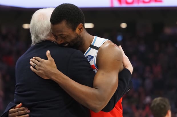 Spurs coach Gregg Popovich hugs Sacramento Kings forward Harrison Barnes (40) before the game at Golden 1 Center. 