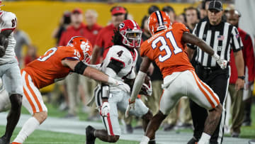 Sep 4, 2021; Charlotte, North Carolina, USA; Georgia Bulldogs running back James Cook (4) is chased by Clemson Tigers linebacker Baylon Spector (10) and cornerback Mario Goodrich (31) during the first quarter at Bank of America Stadium. Mandatory Credit: Jim Dedmon-USA TODAY Sports