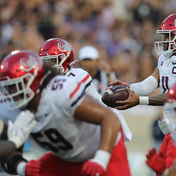 Arizona Wildcats quarterback Noah Fifita (11) hikes the ball during the first quarter of the game against Kansas State at Bill Snyder Family Stadium on Friday, September 13, 2024.