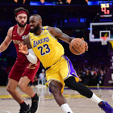 Dec 31, 2024; Los Angeles, California, USA; Los Angeles Lakers forward LeBron James (23) moves to the basket against Cleveland Cavaliers guard Max Strus (1) during the first half at Crypto.com Arena. Mandatory Credit: Gary A. Vasquez-Imagn Images