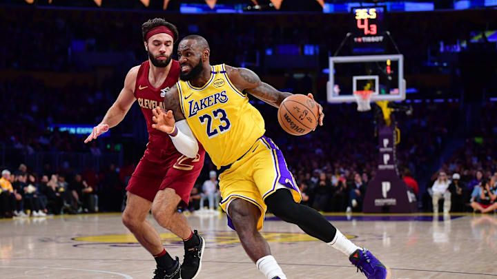 Dec 31, 2024; Los Angeles, California, USA; Los Angeles Lakers forward LeBron James (23) moves to the basket against Cleveland Cavaliers guard Max Strus (1) during the first half at Crypto.com Arena. Mandatory Credit: Gary A. Vasquez-Imagn Images