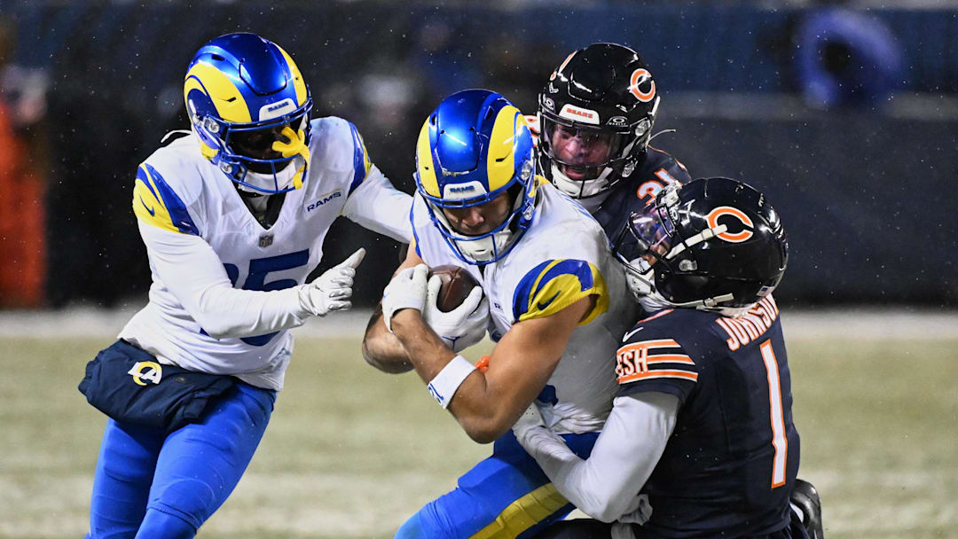 Jan 18, 2026; Chicago, IL, USA; Los Angeles Rams wide receiver Puka Nacua (12) runs after the catch against Chicago Bears cornerback Jaylon Johnson (1) during overtime of an NFC Divisional Round game at Soldier Field. Mandatory Credit: Matt Marton-Imagn Images
