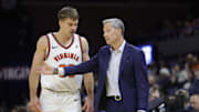 Nov 28, 2025; Charlottesville, Virginia, USA; Virginia Cavaliers head coach Ryan Odom (right) speaks to Cavaliers guard Dallin Hall (30) on the sidelines against the Queens University of Charlotte Royals during the second half at John Paul Jones Arena. Mandatory Credit: Amber Searls-Imagn Images