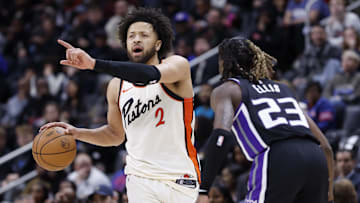 Apr 7, 2025; Detroit, Michigan, USA;  Detroit Pistons guard Cade Cunningham (2) dribbles defended by Sacramento Kings guard Keon Ellis (23) in the second half at Little Caesars Arena. Mandatory Credit: Rick Osentoski-Imagn Images