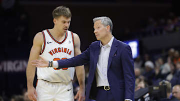 Nov 28, 2025; Charlottesville, Virginia, USA; Virginia Cavaliers head coach Ryan Odom (right) speaks to Cavaliers guard Dallin Hall (30) on the sidelines against the Queens University of Charlotte Royals during the second half at John Paul Jones Arena. Mandatory Credit: Amber Searls-Imagn Images