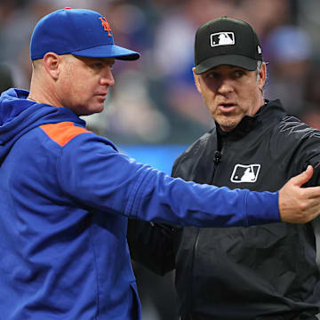 New York Mets manager Carlos Mendoza talks with umpire Sean Barber after an unique play.