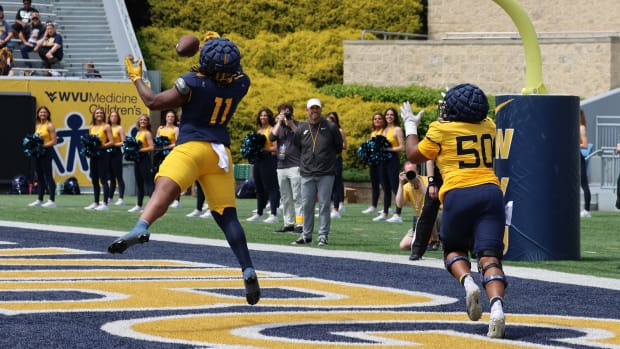 West Virginia University defensive lineman TJ Jackson breaks up the pass attended for redshirt senior offensive lineman Brandon Yates (50) in a 1v1 drill during the 2024 Gold-Blue Spring Game.
