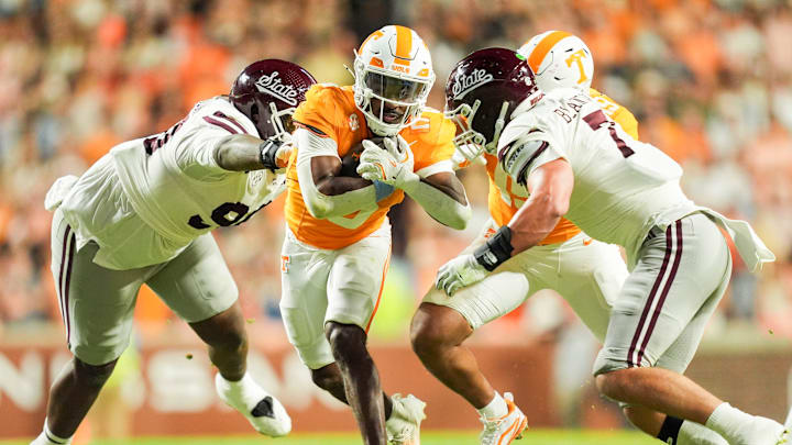 Tennessee running back Dylan Sampson (6) gets tackled by Mississippi State defensive lineman Kai McClendon (90) and Mississippi State linebacker Stone Blanton (7) during a college football game between Tennessee and Mississippi State at Neyland Stadium in Knoxville, Tenn., on Saturday, Nov. 9, 2024.