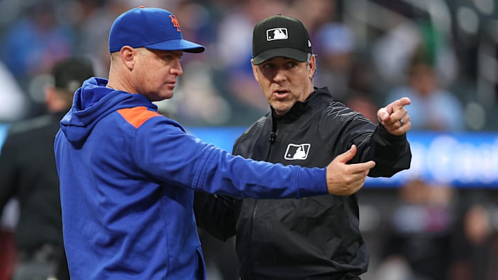 New York Mets manager Carlos Mendoza talks with umpire Sean Barber after an unique play. New York Mets manager Carlos Mendoza talks with umpire Sean Barber after an unique play.