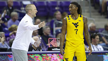 Feb 5, 2025; Fort Worth, Texas, USA;  West Virginia Mountaineers guard Javon Small (7) speaks with West Virginia Mountaineers head coach Darian DeVries during the second half against the TCU Horned Frogs at Ed and Rae Schollmaier Arena. Mandatory Credit: Kevin Jairaj-Imagn Images