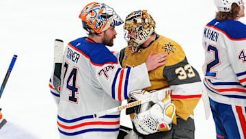 May 14, 2025; Las Vegas, Nevada, USA; Edmonton Oilers goaltender Stuart Skinner (74) shakes hands with Vegas Golden Knights goaltender Adin Hill (33) after the Oilers defeated the Vegas Golden Knights 1-0 during an overtime period, completing a 4-1 series win during game five of the second round of the 2025 Stanley Cup Playoffs at T-Mobile Arena. Mandatory Credit: Stephen R. Sylvanie-Imagn Images