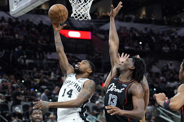San Antonio Spurs guard Blake Wesley (14) drives toward the basket while being defended by Detroit Pistons center James Wiseman (13).