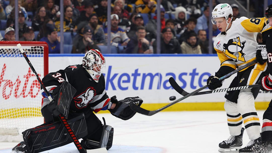 Feb 5, 2026; Buffalo, New York, USA;  Pittsburgh Penguins center Ben Kindel (81) tries to deflect a shot on Buffalo Sabres goaltender Alex Lyon (34) during the third period at KeyBank Center. Mandatory Credit: Timothy T. Ludwig-Imagn Images