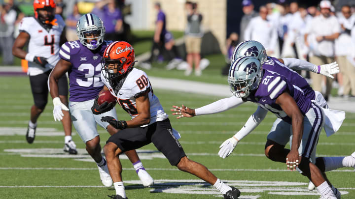 Oct 29, 2022; Manhattan, Kansas, USA; Oklahoma State Cowboys wide receiver Brennan Presley (80) is chased by several Kansas State Wildcats defenders during the first quarter at Bill Snyder Family Football Stadium. Mandatory Credit: Scott Sewell-USA TODAY Sports