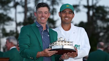 Rory McIlroy and caddie Harry Diamond hold the winner's trophy after winning the 2025 Masters at Augusta National Golf Club