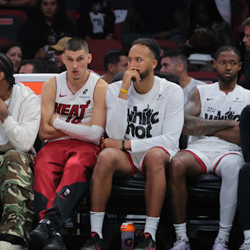 Apr 28, 2025; Miami, Florida, USA; Miami Heat guard Tyler Herro (center) looks on from the bench against the Cleveland Cavaliers in the fourth quarter during game four for the first round of the 2025 NBA Playoffs at Kaseya Center. Mandatory Credit: Sam Navarro-Imagn Images