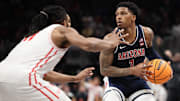 Arizona Wildcats guard Caleb Love (1) attempts to dribble the ball past Houston Cougars forward Joseph Tugler (11) during the second half for the Big 12 Conference Tournament Championship game at T-Mobile Center.
