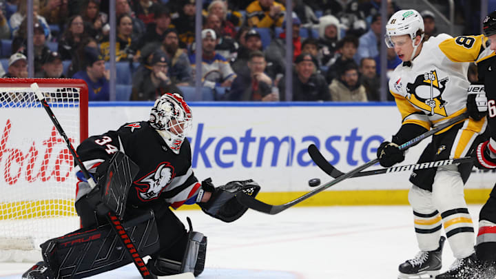 Feb 5, 2026; Buffalo, New York, USA;  Pittsburgh Penguins center Ben Kindel (81) tries to deflect a shot on Buffalo Sabres goaltender Alex Lyon (34) during the third period at KeyBank Center. Mandatory Credit: Timothy T. Ludwig-Imagn Images