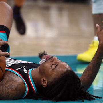 Nov 9, 2025; Memphis, Tennessee, USA; Memphis Grizzlies guard Ja Morant (12) lays on the court during the third quarter against the Oklahoma City Thunder at FedExForum. Mandatory Credit: Petre Thomas-Imagn Images