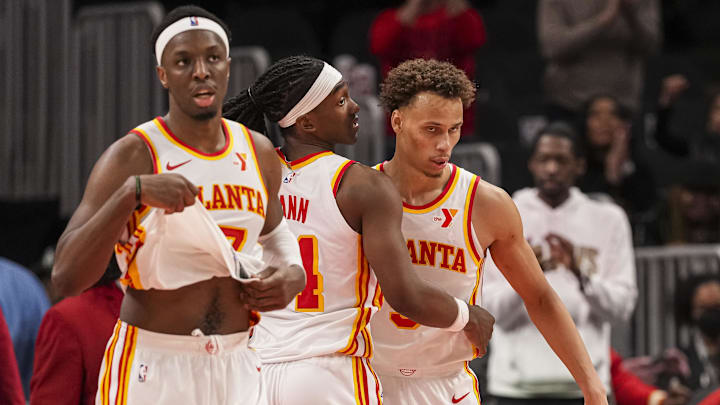 Mar 10, 2025; Atlanta, Georgia, USA; Atlanta Hawks forward Onyeka Okongwu (17) guard Terance Mann (14) and guard Dyson Daniels (5) react after defeating the Philadelphia 76ers  at State Farm Arena. Mandatory Credit: Dale Zanine-Imagn Images