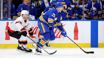 Mar 25, 2025; Buffalo, New York, USA;  Buffalo Sabres defenseman Owen Power (25) carries the puck as Ottawa Senators defenseman Tyler Kleven (43) defends during the second period at KeyBank Center. Mandatory Credit: Timothy T. Ludwig-Imagn Images