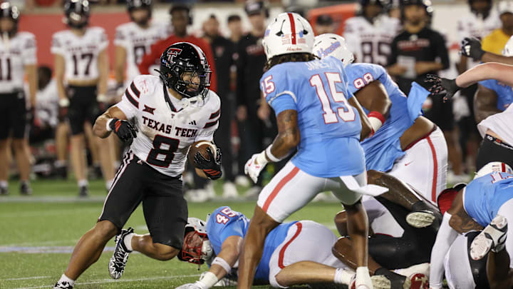 Oct 4, 2025; Houston, Texas, USA; Texas Tech Red Raiders running back Cameron Dickey (8) rushes against Houston Cougars defensive back Will James (15) in the second half at TDECU Stadium. Mandatory Credit: Thomas Shea-Imagn Images