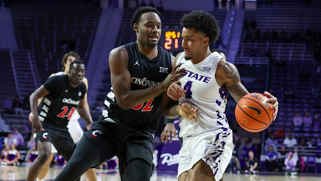 Feb 11, 2026; Manhattan, Kansas, USA; Kansas State Wildcats guard P.J. Haggerty (4) is guarded by Cincinnati Bearcats guard Jalen Celestine (32) during the second half at Bramlage Coliseum. Mandatory Credit: Scott Sewell-Imagn Images