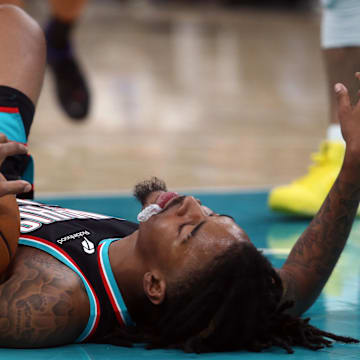 Nov 9, 2025; Memphis, Tennessee, USA; Memphis Grizzlies guard Ja Morant (12) lays on the court during the third quarter against the Oklahoma City Thunder at FedExForum. Mandatory Credit: Petre Thomas-Imagn Images