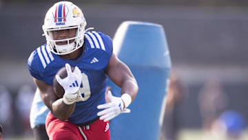 Kansas redshirt senior running back Daniel Hishaw Jr. (9) works through drills during an outdoor practice on Thursday, March 27, 2025.