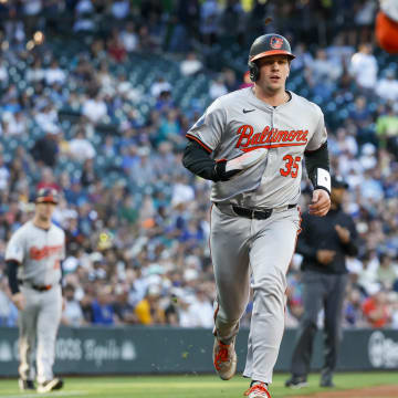 Jul 3, 2024; Seattle, Washington, USA; Baltimore Orioles catcher Adley Rutschman (35) scores a run against the Seattle Mariners during the third inning at T-Mobile Park.