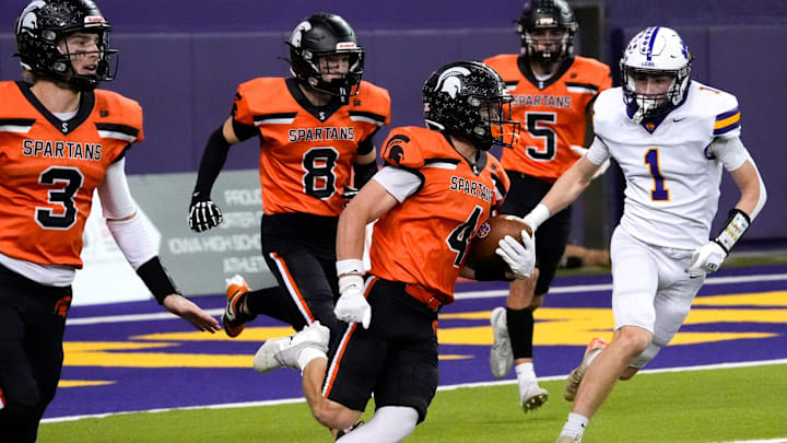 Solon defensive back Maddox Kelley (4) runs with the ball after intercepting a pass from the Nevada Cubs Nov. 15, 2025 during a Class 3A Iowa high school football semifinal at the UNI-Dome in Cedar Falls, Iowa.