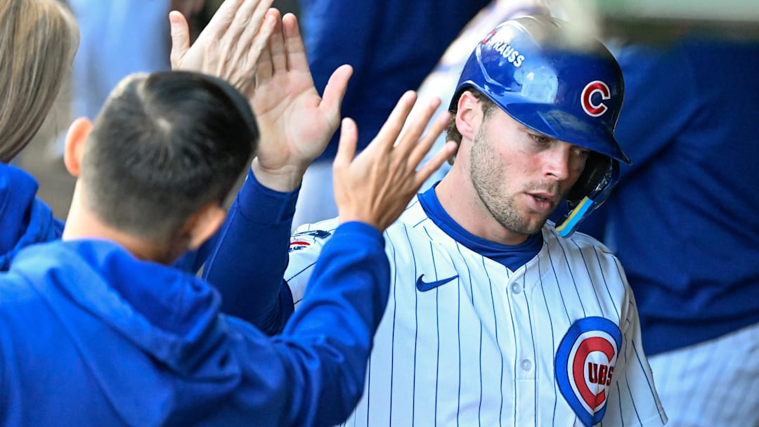 Oct 8, 2025; Chicago, Illinois, USA; Chicago Cubs second baseman Nico Hoerner (2) celebrates with teammates after scoring a run against the Milwaukee Brewers in the first inning during game three of the NLDS round for the 2025 MLB playoffs at Wrigley Field. Mandatory Credit: Matt Marton-Imagn Images