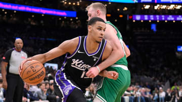 Apr 5, 2024; Boston, Massachusetts, USA; Sacramento Kings forward Keegan Murray (13) drives the ball  against Boston Celtics forward Sam Hauser (30) during the second half at TD Garden. Mandatory Credit: Eric Canha-USA TODAY Sports