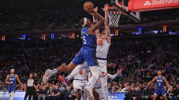 Jan 15, 2024; New York, New York, USA; Orlando Magic forward Paolo Banchero (5) goes to the basket as New York Knicks center Isaiah Hartenstein (55) defends during the first half at Madison Square Garden. 