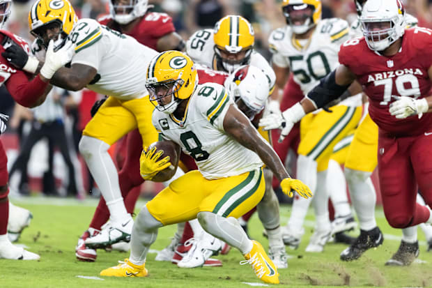 Josh Jacobs runs with the ball.
