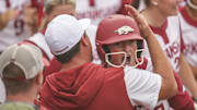 Arkansas infielder Bri Ellis (77) reacts with teammates and coaches after hitting a walk off grand slam home run against Georgia at Jack Turner Stadium. 