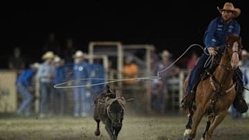 A cowboy competes in the team roping competition