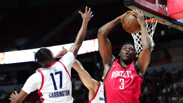 Houston Rockets guard Reece Beekman (3) grabs a rebound against the Washington Wizards 